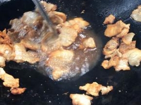 腊肉焯水后放入锅中，煎至金黄色