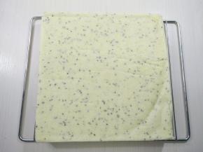 取出轻震烤盘震出热气，将蛋糕倒扣撕掉底部油纸晾凉。