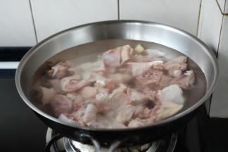 锅里注入适量的冷水，放入30ml的黄酒，5片姜和鸡块，大火煮开。
