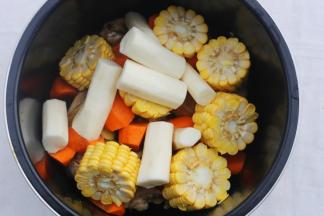 鸡肉连同姜片一起放入锅中，加上胡萝卜、玉米、山药