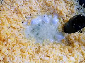 拨开米饭在锅中空出中间，加入少许油，倒入蛋白部分