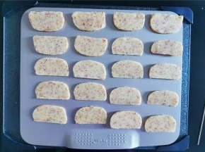 冻硬后用刀切成均匀厚度的片状，放置学厨的烤盘中进行烤制。