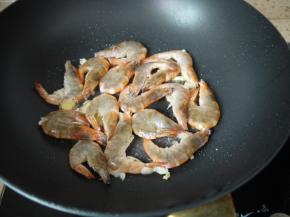 把大虾倒入锅中，先把虾的一面烧红再翻炒一下。