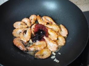 炒至大虾变色，8分熟时加入番茄沙司、酱油、蚝油、糖和盐，继续翻炒均匀。加入番茄酱后可以转小火，火太大容易烧干。