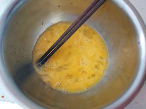 鸡蛋磕入小盆内，加一点点水搅打顺滑。