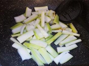 接着把蒲瓜段倒入锅中翻炒下，炒制变软。