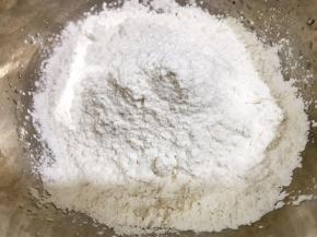 盆里加入糯米粉和粘米粉，先用100克开水烫面，再加入冷水揉成面团