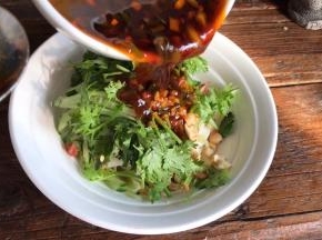 放入黄瓜丝、香菜碎、花生碎和拌好的调料