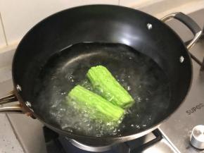 锅里烧开水，放一小勺盐，把苦瓜入锅中焯水；
