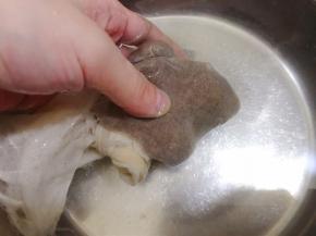 把包有冰粉籽的纱布放入盆里搓出黏液，两手像搓衣服那样轻轻搓就好