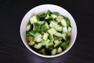 把干辣椒剁碎、大蒜拍碎去皮切碎，热锅倒油爆香蒜末。把切好的黄瓜放入碗里，接着把爆香的油放入碗里拌均。