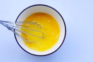 鸡蛋磕入碗中打散。