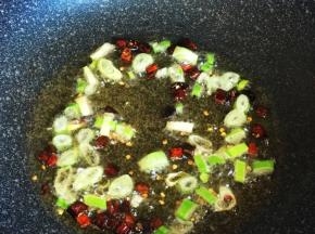 油热后爆香红椒段、葱花。