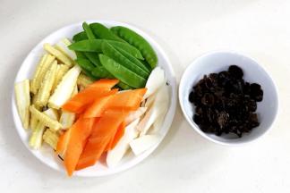 木耳提早用温水泡发40分钟，洗净。胡萝卜和山药去皮切好，玉米笋对半切，荷兰豆去筋洗净。