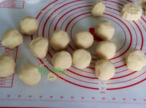 炒好绿豆泥，用一个大盘子摊开，放通风处，放凉至不烫手状态，分50克一个，揉成小团