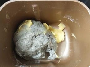 3、大概揉10分钟成团后，放入软化的黄油继续揉。