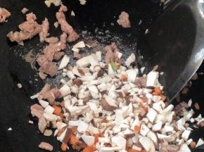 加入香菇碎和胡萝卜碎。炒熟