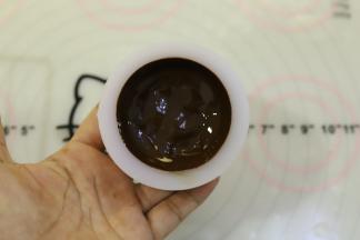 分别将巧克力液倒入模具内，晃动到整个模具四周都粘满了巧克力。