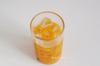 准备好一个容量是300ml的玻璃杯，将冰块放入，把芒果汁倒入杯里。