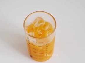 准备好一个容量是300ml的玻璃杯，将冰块放入，把芒果汁倒入杯里。