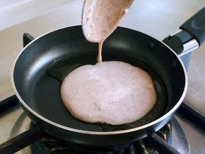 淋入一汤匙半面糊，并转动锅底，使面糊均匀摊薄，一直处于小伙状态。