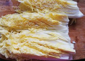 首先把菜洗净，切半再把菜竖着切，记住不是横切（如图所示）。