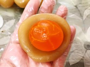 取一份莲蓉馅包入一个咸蛋黄