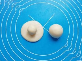 取一个油皮面团压扁，放上油酥面团包好。