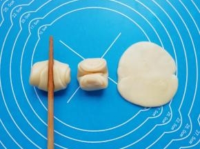 松弛好的卷卷用筷子从中间压一下，两头向上压扁，擀成圆形的酥饼皮。