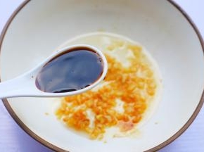 准备一个大碗，加入一半蒜末，加2勺生抽，