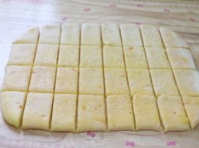 表面撒粗粒砂糖，并用刀分割成方形或者是长方形的饼干形状。1