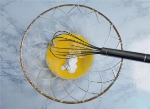 把鸡蛋磕入碗中打散，接着倒入糖粉和蜂蜜用打蛋器充分搅拌。