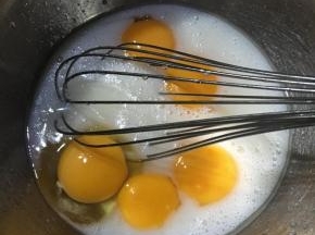 加入一个全蛋和4个蛋黄，搅拌均匀。
