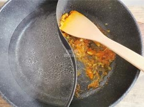 另一边倒入适量的清水，锅中爆香后要倒入黄灯笼辣椒酱翻炒出香味。