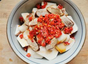 接着铺入两勺剁椒酱在上面，空隙处也填入一些。