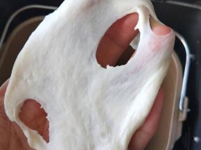 ８、揉到扩展阶段，能拉出膜，但是边缘有锯齿状态是加入黄油继续揉。