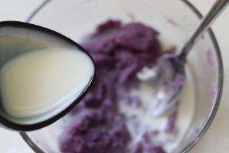 用牛奶或者用配方中的水冲好的奶粉溶液，倒入到80克紫薯泥中，搅匀扮成奶香紫薯泥。