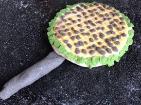 把黑色面团搓成圆球长条，做出向日葵的树杆