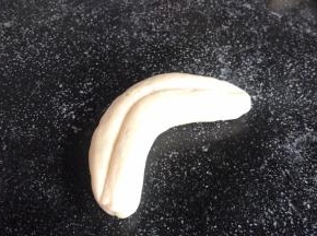 在中间压出一道印痕，再整成弯香蕉型