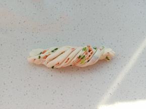 12.	捏住两头，反向卷一下