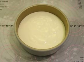 6寸固底模底部放上一张圆形的油纸，倒入蛋糕糊，轻震去气泡。