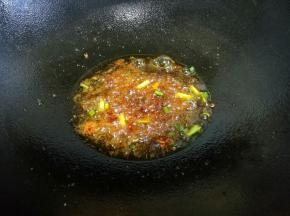 热锅热油，蒜末、葱白加一勺豆瓣酱炒出红油。
