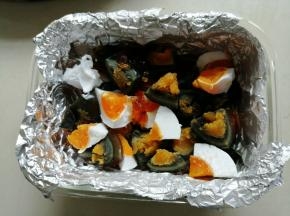 耐高温玻璃盒内铺一张锡纸，或耐高温保鲜膜，方便蒸熟后脱模，把切成小块的皮蛋和咸蛋放在玻璃盒底部，为了使蒸好的三色蛋切面好看，建议咸蛋和皮蛋错开摆放