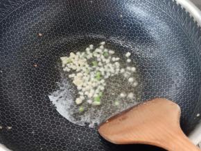 另起锅，锅热放油，油热入蒜碎与葱白翻炒出香味。