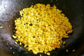 鸡蛋打散下油锅煎熟用锅铲铲成碎末。