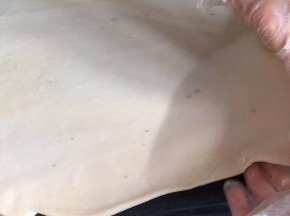 再从上往下，一边卷一边拉面皮，拉的越薄越好，卷成卷
