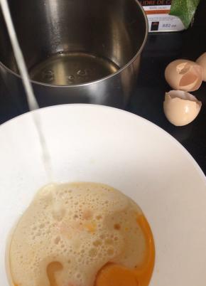 蛋黄中加入一半的糖，玉米油、牛奶备用