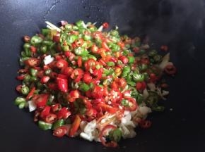 起锅热油了，倒入适量油，无需太多，油一定要烧热后倒入辣椒碎、蒜末、姜碎，不停翻炒；