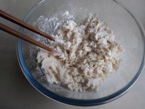 和面盆里装入面粉、糖，可以加一点奶粉，大概10克。倒入酵母牛奶液，用筷子拌成絮状