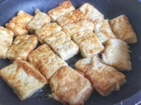 煎豆腐期间，调酱汁；碗中倒入生抽、糖、剁辣椒、小半碗水，搅拌均匀，葱花切碎；